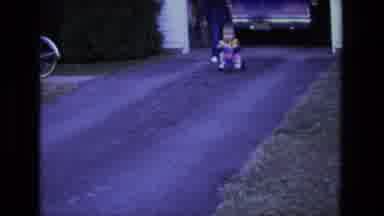 California USA (1975): Home Video Of Child Riding Tricycle Down A Driveway