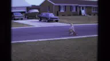 California USA (1975): Boy Riding Tricycle On An Empty Street