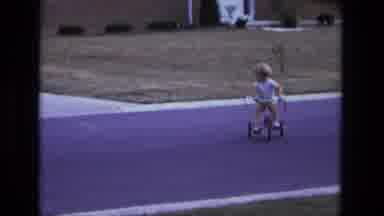 California USA (1975): Young Boy Cycling Around Suburban Neighbourhood In A