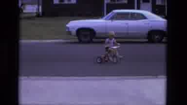 California USA (1975): Vintage Footage Of Child On Tricycle Playing On The Road