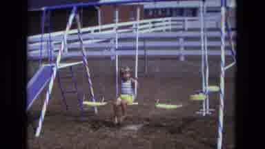 California USA (1975): A Child Playing On A Playground With No Shoes On A Sunny