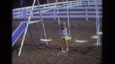 California USA (1975): Vintage Film Of A Young Girl Playing On A Swing In A Park
