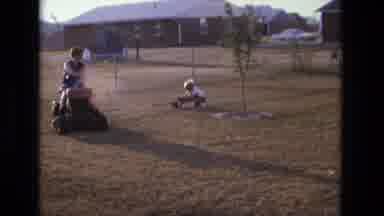 California USA (1975): Boy In A Wagon Being Pulled By A Woman Driving A Tractor