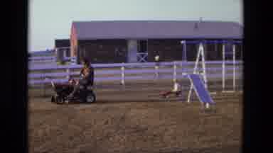 California USA (1975): Man Driving A Mower Tractor In A Farm During The Day And