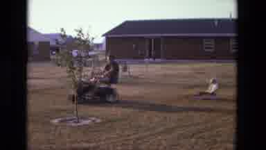 California USA (1975): Father Loving Tows His Young Song In A Toy Wagon At Sunset