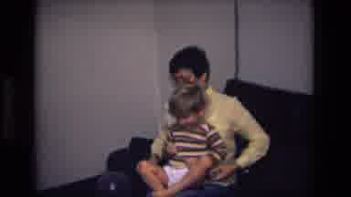 California USA (1975): Old Video Of A Brunette Mom Combing Her Boys Hair