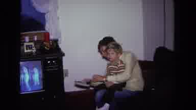 California USA (1975): Getting Our Little Boys Shoes On And Ready To Leave The