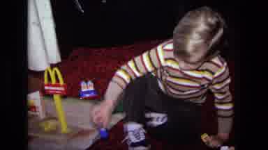 California USA (1975): A Small Boy Playing On The Floor With His Mcdonald's Toy