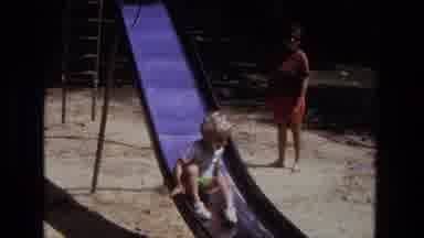 California USA (1975): A Young Boy Slides Down A Metal Sliding Board At A Camp