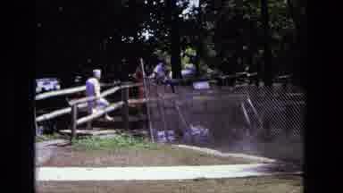 California USA (1975): Family Admires On Small Bridge Admires Lake While Woman