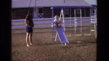 California USA (1975): Woman With Child On Playground In Sunny Day And Typical