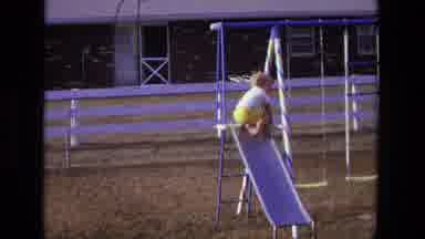 California USA (1975): Small Child Carefully Turning Around At The Top Of A Small