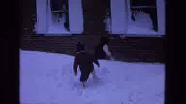 California USA (1975): Two Little Toddlers Walking In Snow In Front Of A House