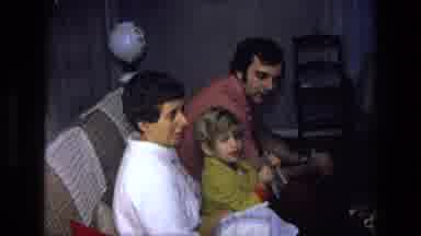 California USA (1975): Three People Two Adults And A Child Sitting On A Couch