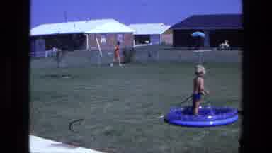California USA (1975): Mom And Young Son Outside Playing And Beating The Heat