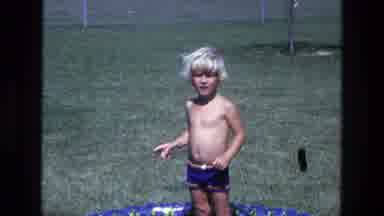 California USA (1975): A Boy Enjoying The Summer While Playing In Pool