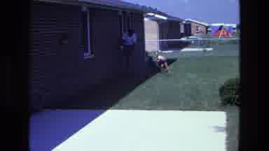 California USA (1975): The Son And Father Are Playing Outside Of His House