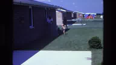 California USA (1975): Family Time Backyard Fun Child Playing Near The Back Of The