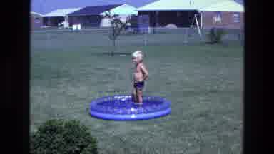 California USA (1975): Kid In The Little Pool Standing Around