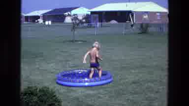 California USA (1975): Kid Is In The Pool Playing