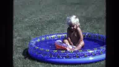 California USA (1975): The Little Kid Is Playing In The Pool Right Outside Of His