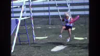 California USA (1975): Young Child Playing On A Playground Swing In The Sun