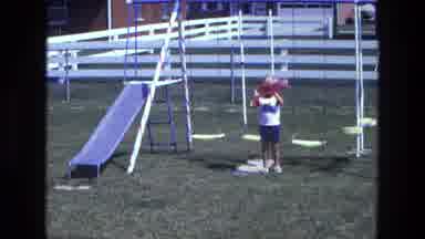 California USA (1975): Swings Child Blonde Slide Yard Throwing Toy Ladder Fence