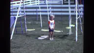 California USA (1975): A Boy Playing In The Park And Running To His Left Side To