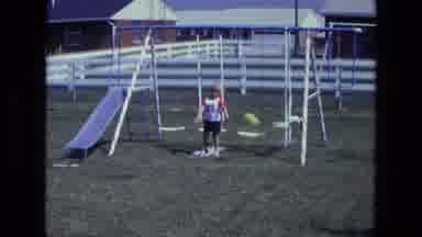 California USA (1975): Young Boy Playing With His Balloon On His Backyard Swing