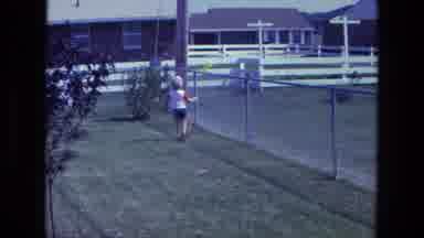 California USA (1975): Little Boy Chasing A Yellow Balloon That Is Being Carried