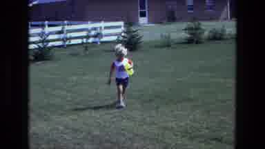 California USA (1975): Child Walking Playing Near Swing Set Windy Day Running With
