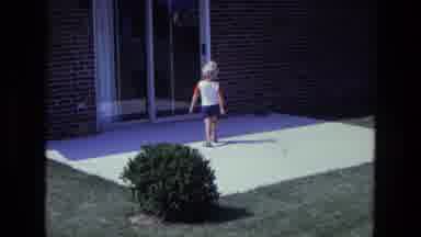 California USA (1975): Blond Child Walking In To The House Using Back Door