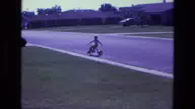 California USA (1975): Home Video Day In Neighborhood Child In Street On Tricycle