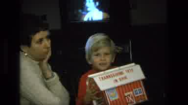 California USA (1975): Inside A Home With An Adult Woman And Little Boy Holding A