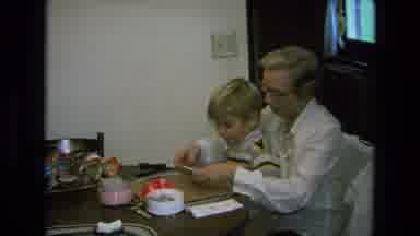 California USA (1975): Caucasian Mother Helping Her Son With Art And Craft Work At