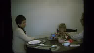 California USA (1975): Little Boy At Dinner Time Playing With His Favourite Toy