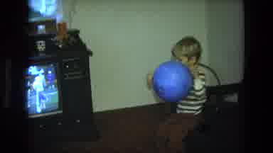 California USA (1975): Boy Plays With A Ball In The Living Room Of His House While