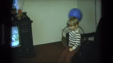 California USA (1975): Young Boy Waving A Blue Balloon Back And Forth In The