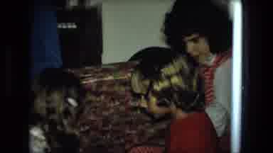 Fort Wayne Indiana (1976): Three Little Children Unwrapping Gifts On Christmas Day