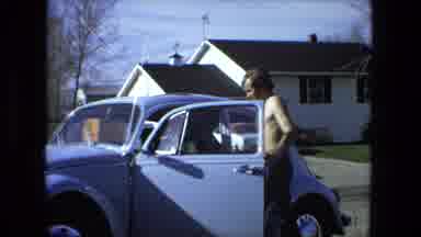Fort Wayne Indiana (1976): Man Changing The Tire Of His Car On The Street With