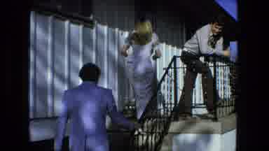 Fort Wayne Indiana (1976): Blonde Lady Followed By A Man Dressed In A Suit Like