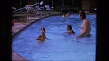 Fort Wayne Indiana (1976): A Man Wades Toward A Pool Ladder As Children Swim And