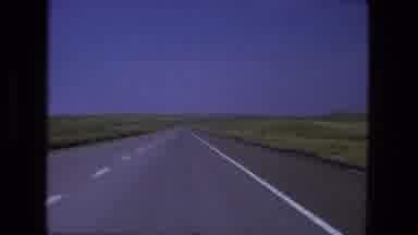Fort Wayne Indiana (1976): A Vehicle Traveling Down A Highway Passes Grasslands
