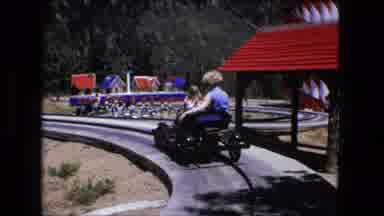 Fort Wayne Indiana (1976): Woman Rides On Small Train In Playground On Sunny And