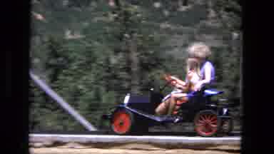 Fort Wayne Indiana (1976): Couple Driving Old-School Black Kart With Red Wheels On