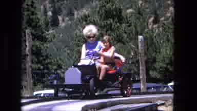 Fort Wayne Indiana (1976): A Woman And A Younger Girl Sit On A Mock Car At An