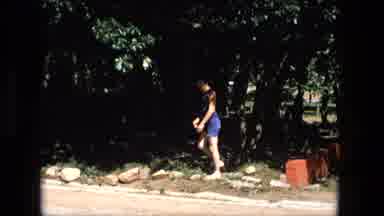 Fort Wayne Indiana (1976): Man In Blue Shorts Standing In Grass Across From Two