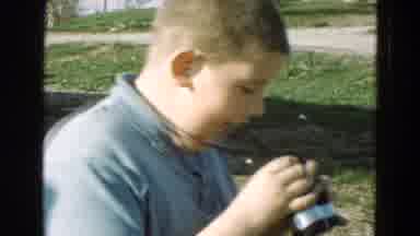 Diller Nebraska (1968): Pre Teen Boy Using Binoculars To Look At A Happy Little
