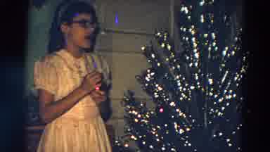 Diller Nebraska (1968): Two Kids Singing Christmas Carols In Front Of A Christmas