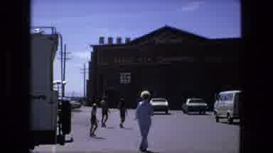 Fort Wayne Indiana (1976): People Walk And Child Makes Funny Face In Front Of Old